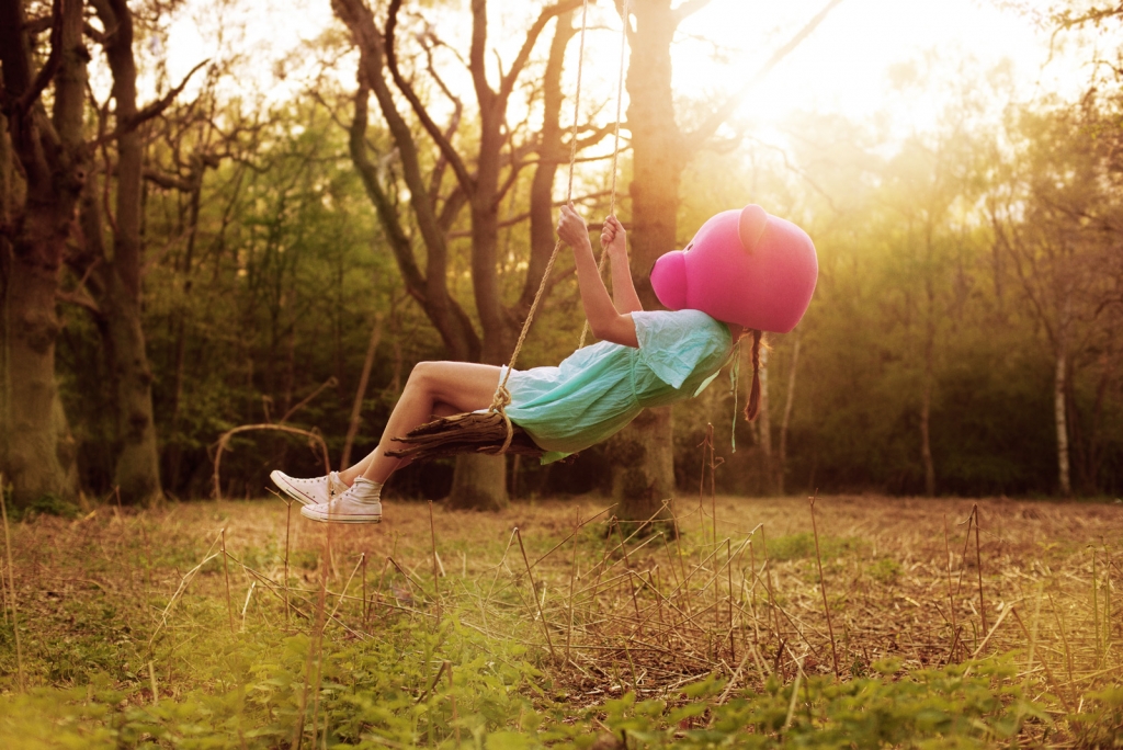 Swinging pink bear - Martina Velika poses in the fine art photograph as the pink bear.