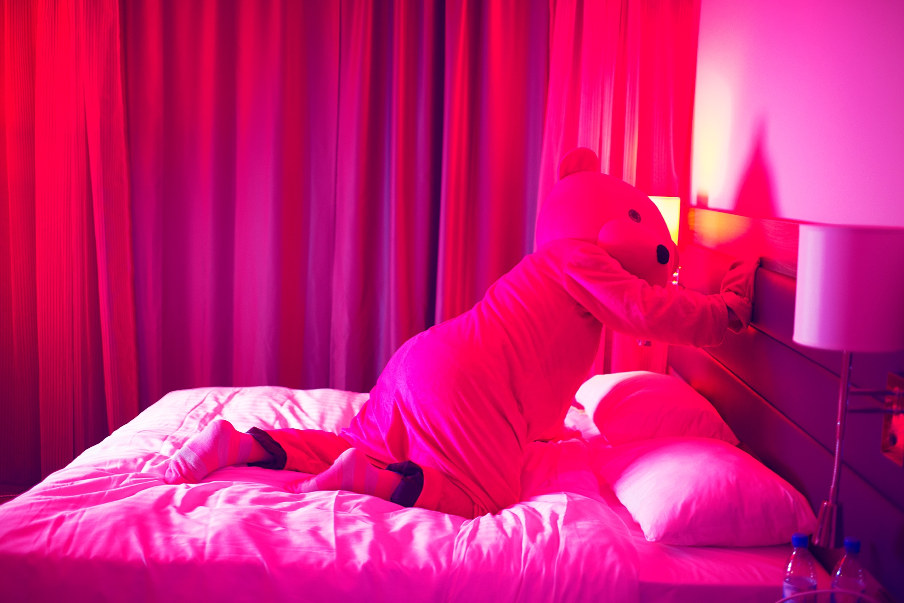 The Bear escapes the box and heads over to the bed.