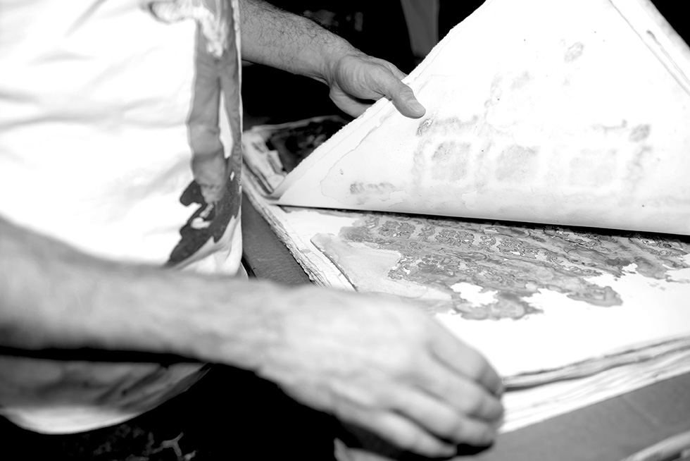 The paint takes several days to dry under the stencil. Once dried I stack the paper to flatten it.